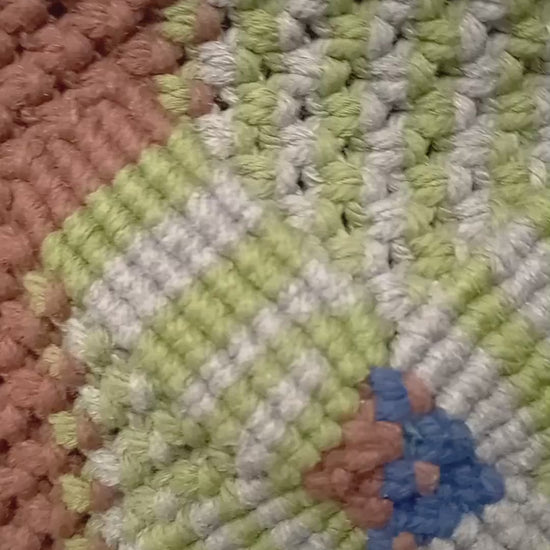 colourful woven bag turned around with zipper open to show the inside.