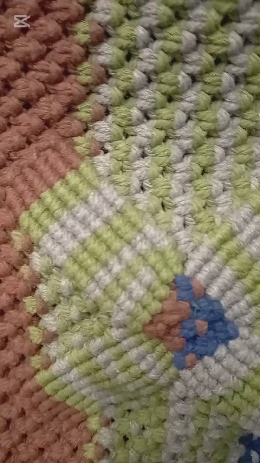 colourful woven bag turned around with zipper open to show the inside.